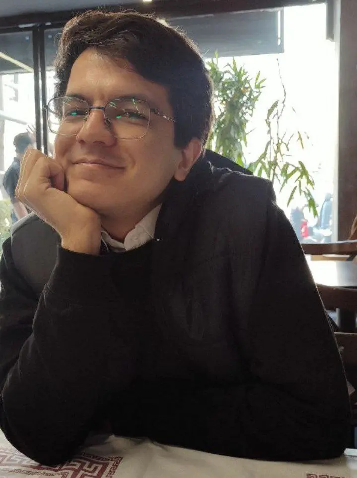 picture of me, wearing glasses and smiling.